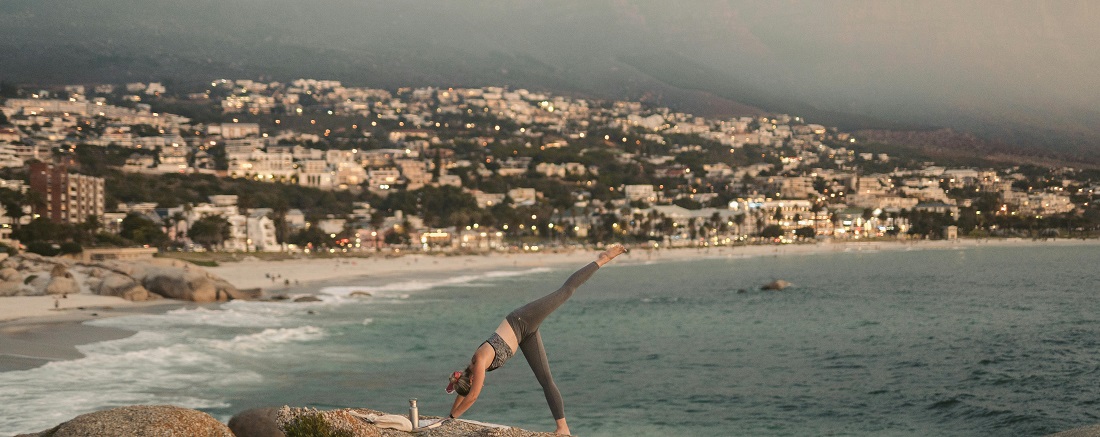 A woman doing yoga on a Cape Town beach