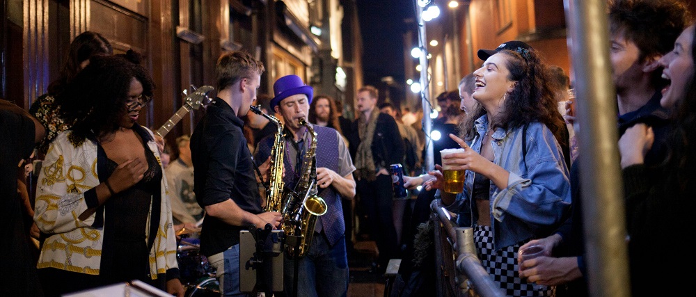 People playing music outdoors by Kellyn Bowler