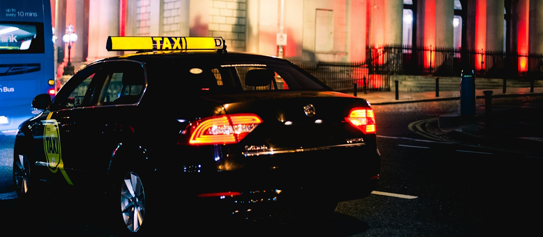 Black taxi at night by Naseem Buras