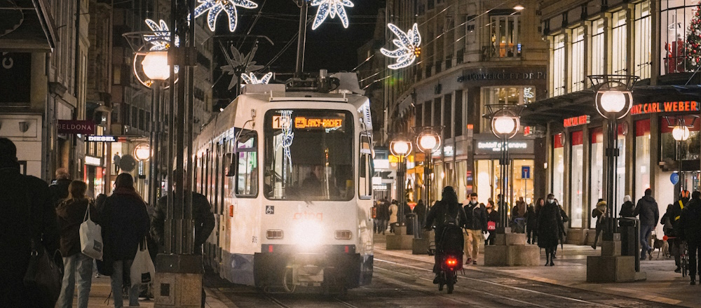 Tram in Nighttime Geneva by Meizhi Lang  on Unsplash