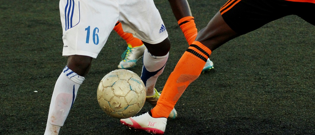 Two players handling a football by Jannik from Unsplash