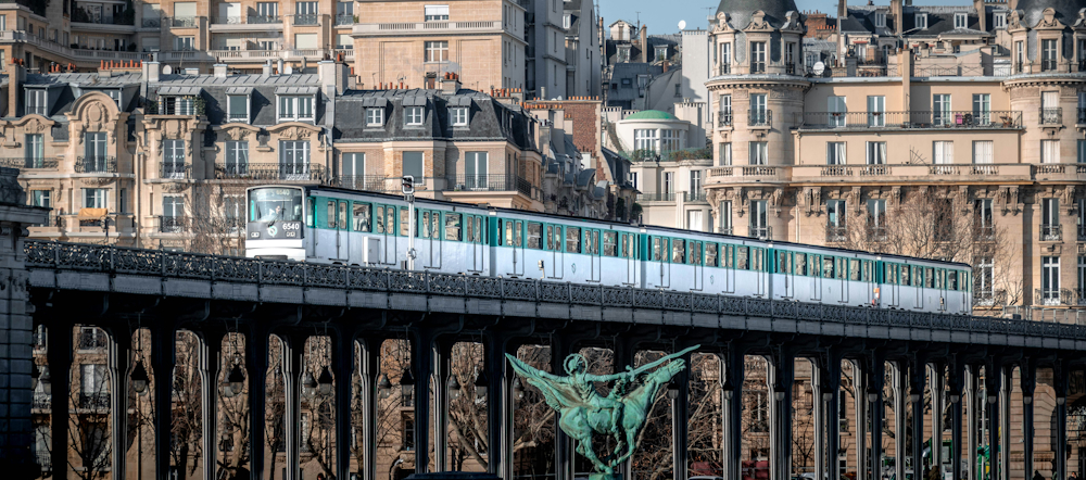 Paris Métro Train on the Pont de Bir‑Hakeim by Louis Paulin on Unsplash