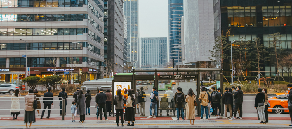 Passengers at a Bus Stop in Seoul by Hanvin Cheong on Unsplash
