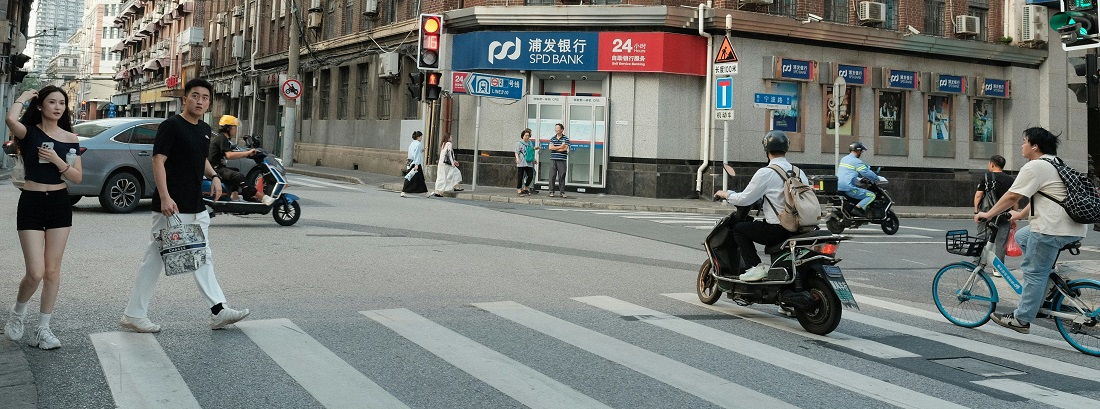 Bicycle and scooter at a Shanghai intersection by Dominic Kurniawan Suryaputra 