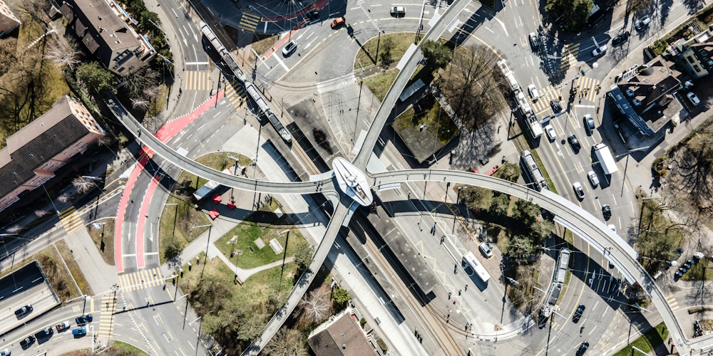 Bucheggplatz Circle with Pedestrian and Rail Overpasses by Patrick Federi on Unsplash