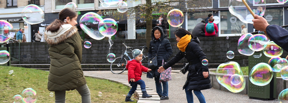 Families playing with bubbles in Belgium park
