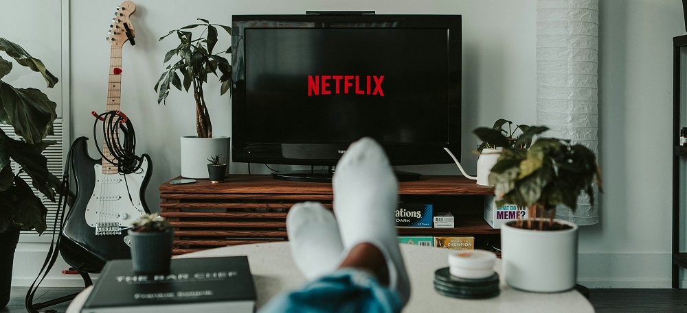 Person watching Netflix on the couch by Mollie Sivaram