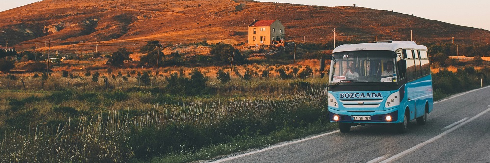 Blue bus on a country road by Tristan Hess