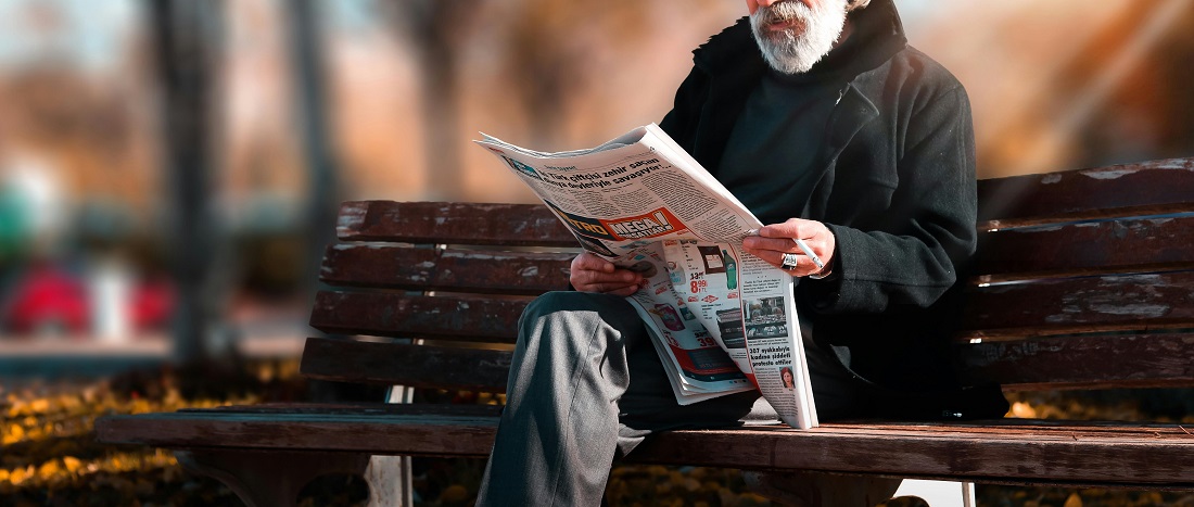 Man reading newspaper by Hasan Albari from Pexels.