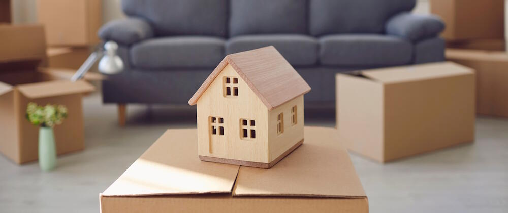 wooden model house on moving box