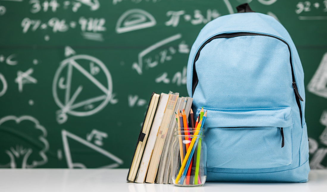 school bag and stationery in a classroom