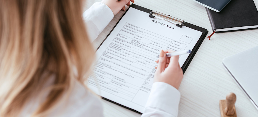 Person filling out a visa application