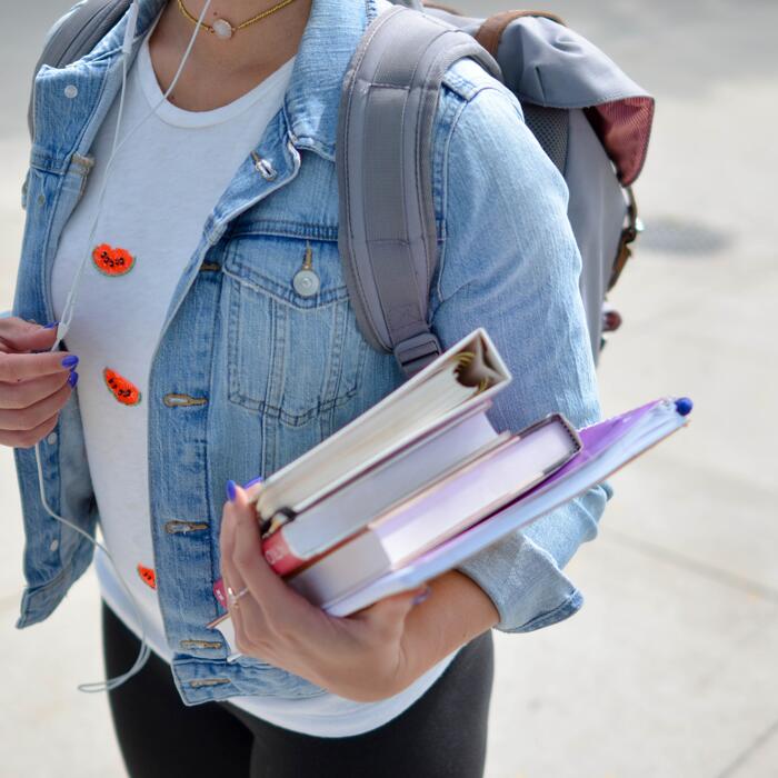 Young woman holding textbooks