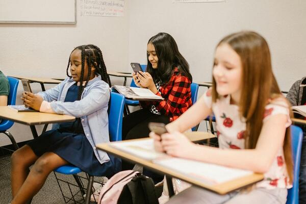 Children using cellphones in class