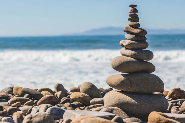 Tower of Pebbles on a Beach by Jeremy Thomas on Unsplash